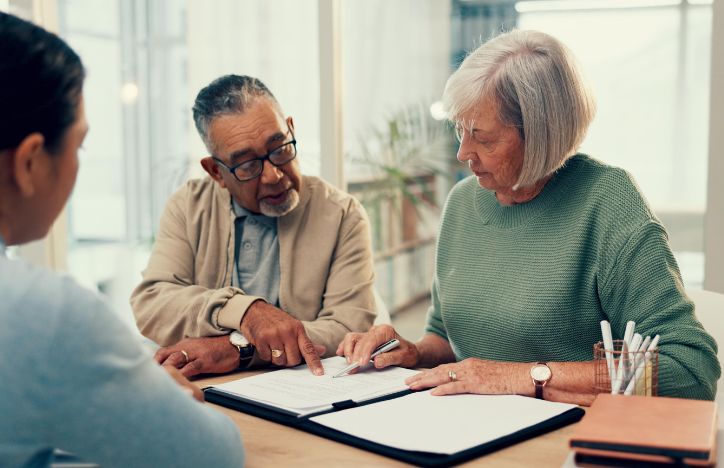 Elderly Couple Signing Document