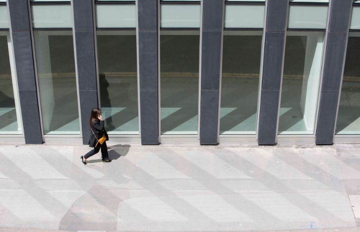 Woman Walking On Phone In City