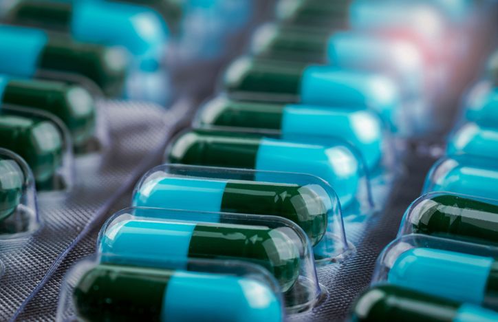 Closeup Of Green And Blue Capsule Pills In Blister Packaging