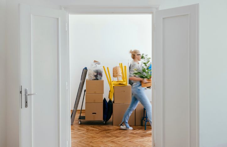 Woman Moving Out With Packing Boxes