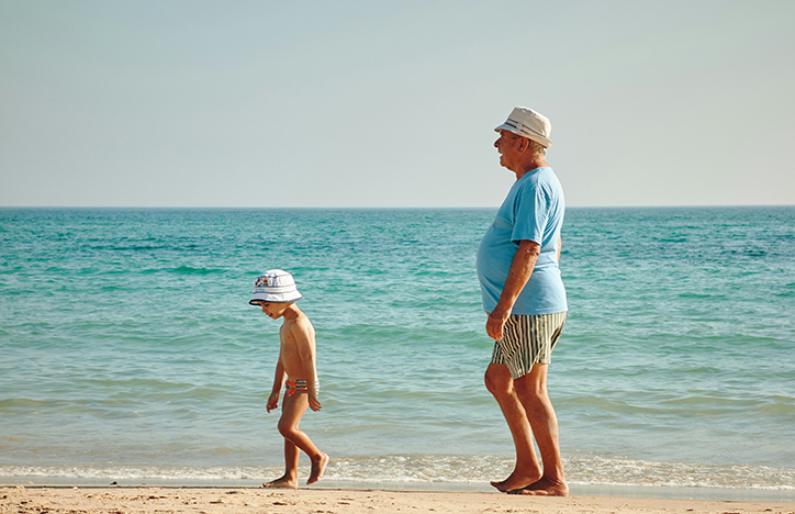 Grandpa With Grandson At The Beach