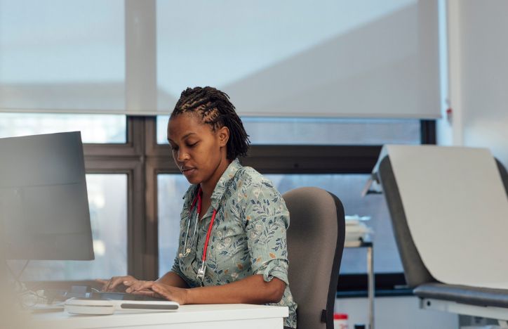 Doctor Working At Computer