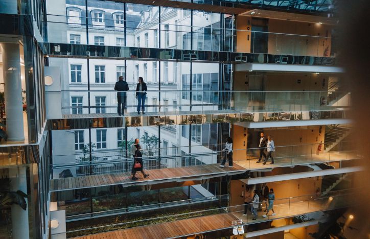 People Walking On Multiple Levels Of An Office Building