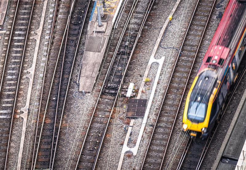 Aerial View Of Train Tracks With A Train Passing Through