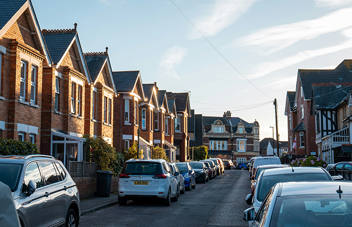 Cars lined up outside of some new development houses.jpg
