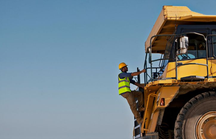 Construction Staff Climbing On To Machinery