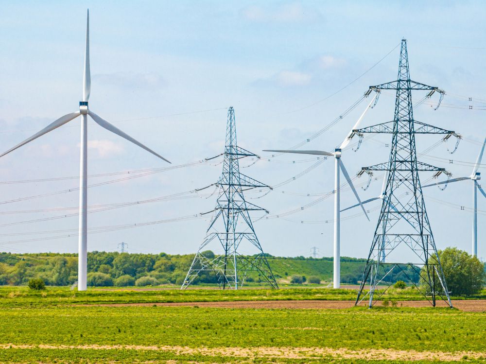 Electric Power Lines And Wind Turbines In A Field