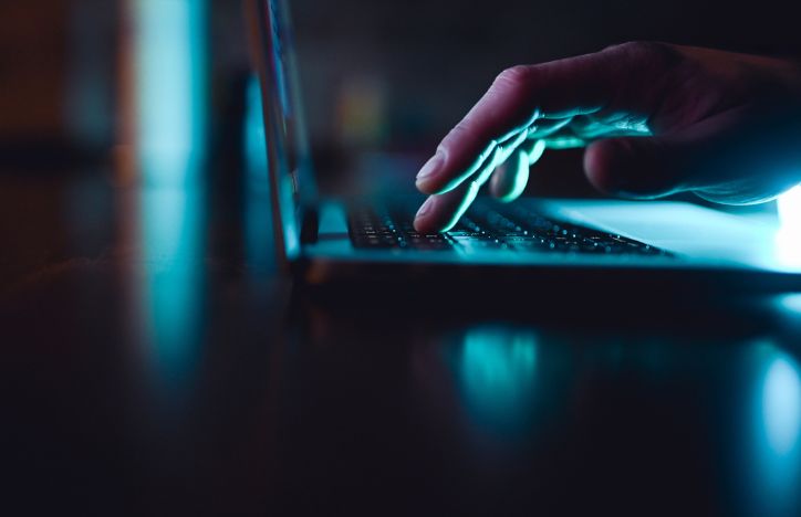 Hand Pressing Keys On Laptop