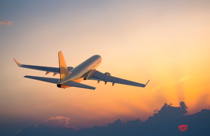 Plane In The Sky At Dawn