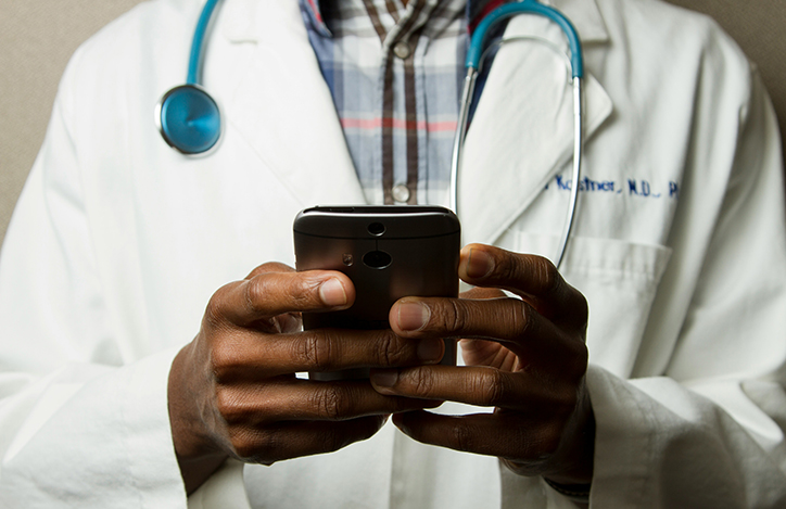 A Doctor Holding A Smartphone