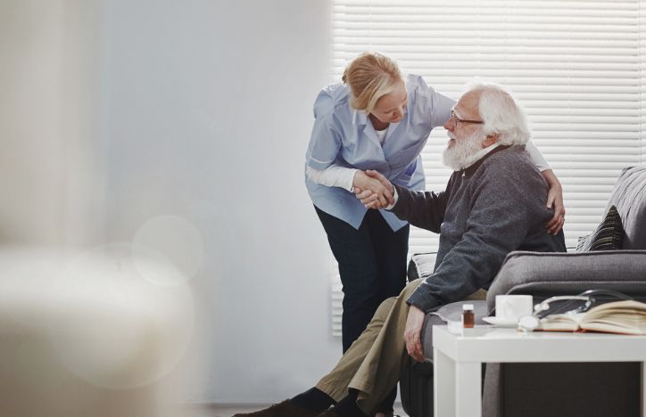 A Carer With An Elderly Patient