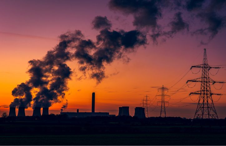Silhouette Of A Power Station's Cooling Towers Against Sunset