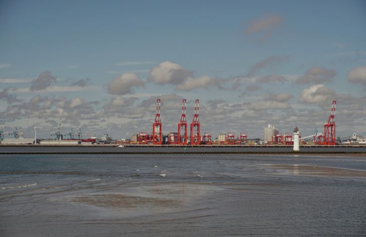 Dockside Structures Sit Along The Waterside At The Port Of Liverpool