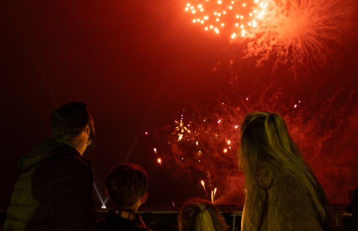 Family Of Four Looking Up At A Firework Display