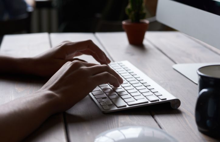 Hands typing on a wireless keyboard.jpg