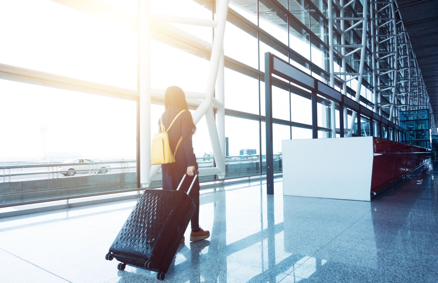 Woman With Suitcase In Airport