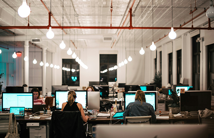 Photo Of People Working In An Office From Behind
