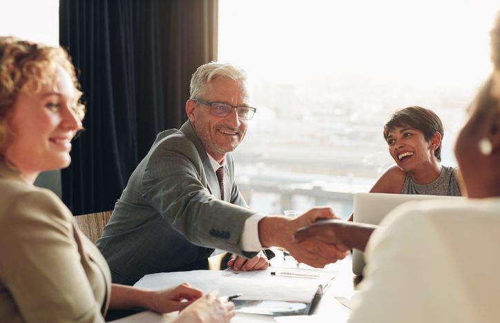 Business Professionals Shaking Hands During A Meeting