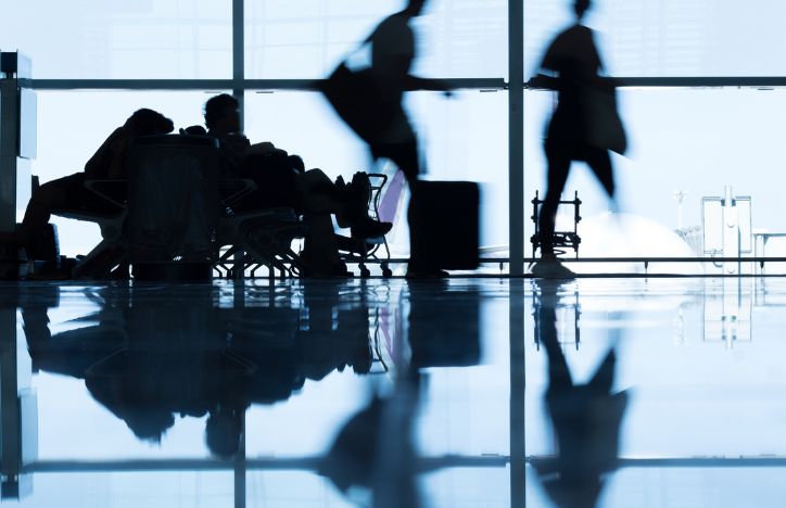 Silhoutted Passengers At An Airport Terminal