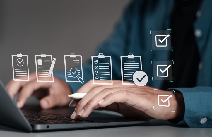 Man On Laptop With Illustrations Of Files And Documents