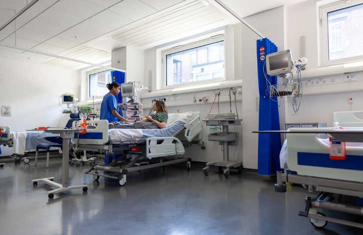 Speaking To Medical Staff From Hospital Bed